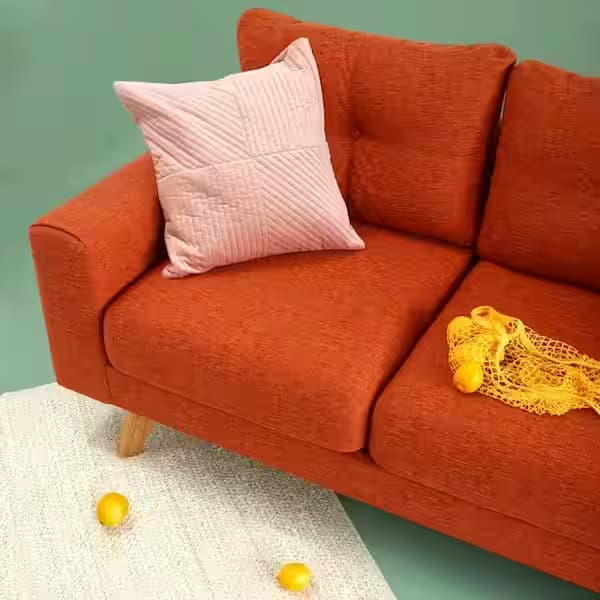Canapea tapițată portocalie cu pernă decorativă